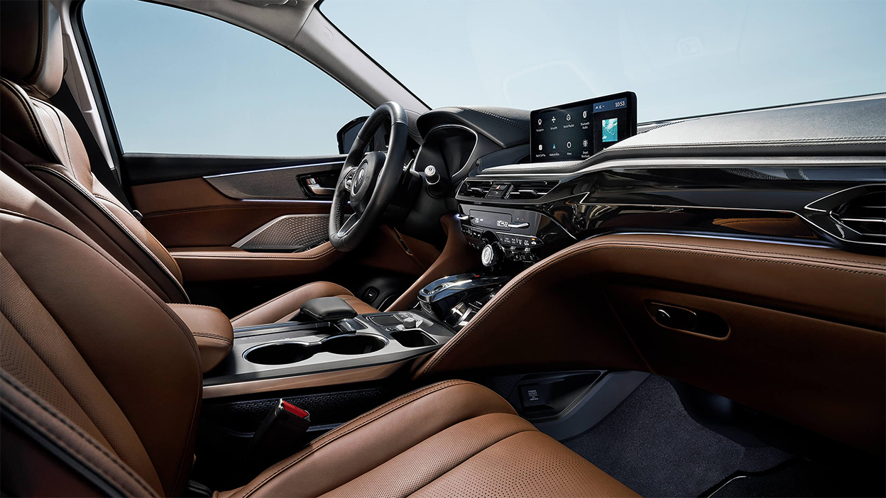 A side view of the front seats in an MDX, featuring a brown interior.
